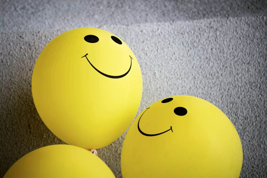 Smiley-faced balloons - a symbol of joy in nature.