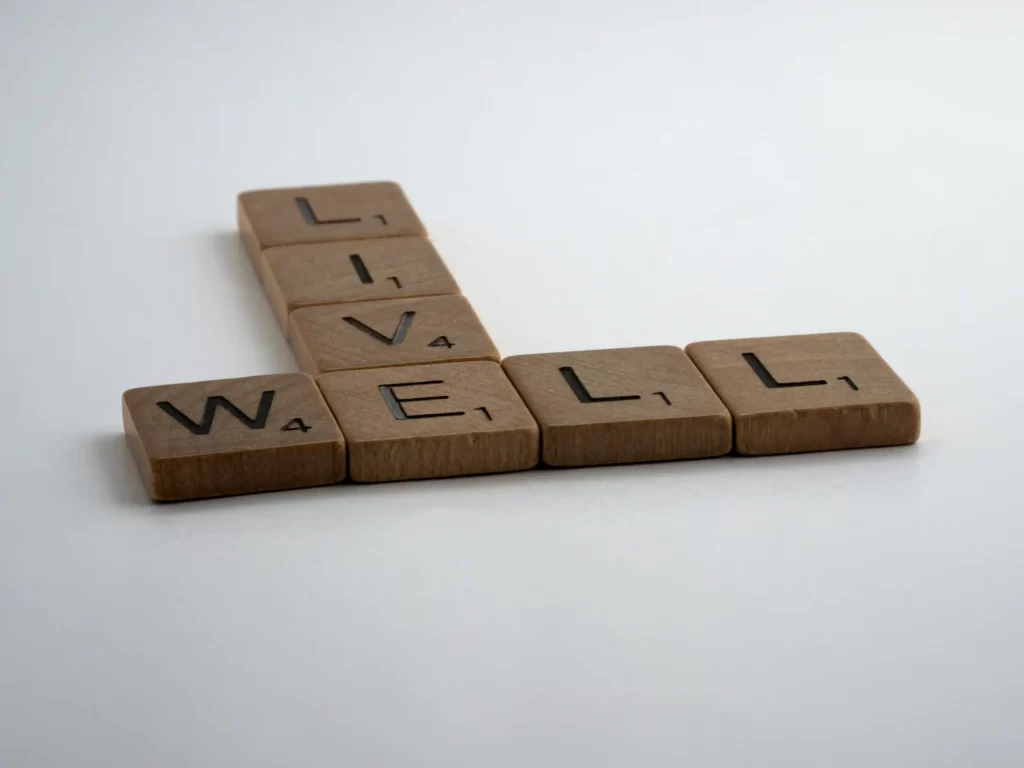 Letter blocks spelling 'LIVE WELL' for holistic health article